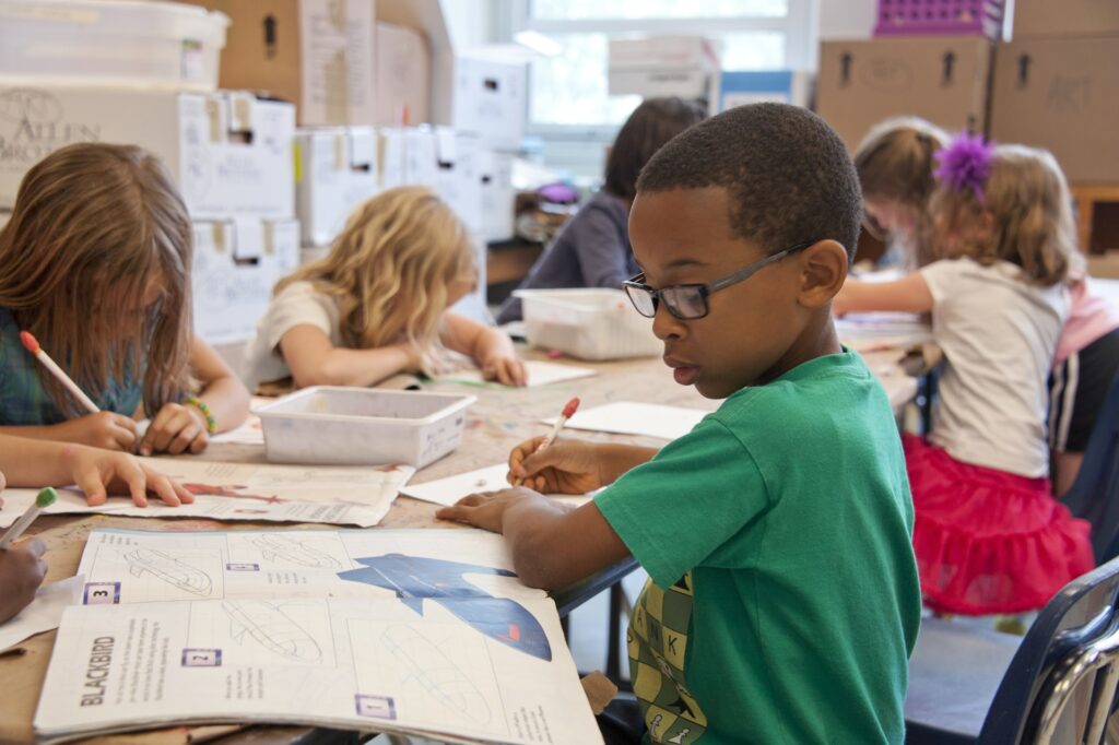 Children colouring in a classroom